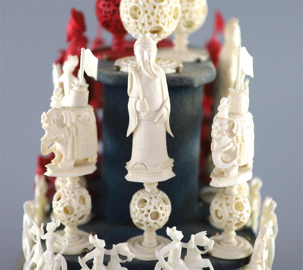 A set of 19th century Cantonese carved and red stained ivory chess pieces under dome, white king 20cm high